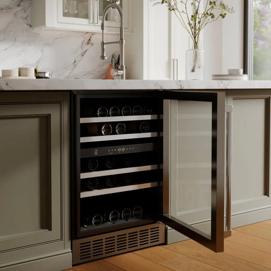 ZLINE 24 in. Monument Dual Zone 44-Bottle Wine Cooler in Stainless Steel (RWV-UD-24) embedded in a kitchen cabinet with marble countertop and window in background