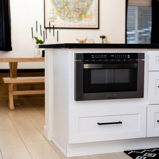 Modern kitchen with white cabinetry, black countertop, and ZLINE 24 in. 1.2 cu. ft. Built-in Microwave Drawer in Black Stainless Steel (MWD-1-BS)
