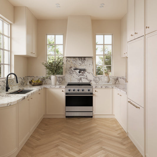 A modern kitchen interior with cream cabinetry, marble countertops and backsplash, light wood herringbone flooring, and a ZLINE Autograph Edition 30 in. 4.2 cu. ft. Marino Induction Range with 4 Element Cooktop and Electric Convection Oven in Stainless Steel with Matte Black Accents (MINRZ-30-MB) centered beneath a white range hood.