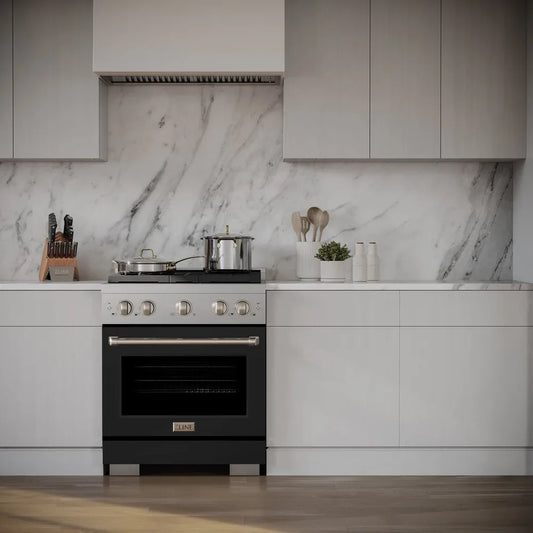 Modern kitchen with ZLINE 30 in. 4.2 cu. ft. Paramount Dual Fuel Range with 4 Burner Gas Cooktop and Electric Convection Oven in Stainless Steel with Black Matte Door (SDR-BLM-30) against a marble backsplash.