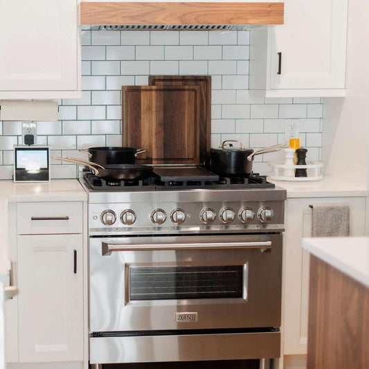 ZLINE 36 in. 4.6 cu. ft. Legacy Dual Fuel Range with 6 Burner Gas Cooktop and Electric Convection Oven in Stainless Steel (RA36) with pots and pans on top of cooktop