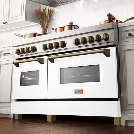 ZLINE Autograph Edition 60 in. 7.4 cu. ft. Legacy Dual Fuel Range with 9 Burner Gas Cooktop and 2 Electric Convection Ovens in Stainless Steel with White Matte Doors and Champagne Bronze Accents (RAZ-WM-60-CB) in a luxury kitchen, from below.
