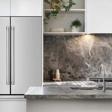 Modern kitchen featuring a stainless steel ZLINE refrigerator, gray marble backsplash, and white cabinetry.