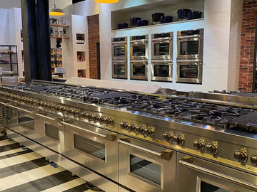 Professional stainless steel ZLINE range and wall ovens in a modern kitchen set from Netflix's Pressure Cooker.