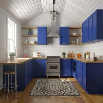 Modern kitchen with vibrant blue cabinets, stainless steel ZLINE range, wood countertops, and white shiplap walls.