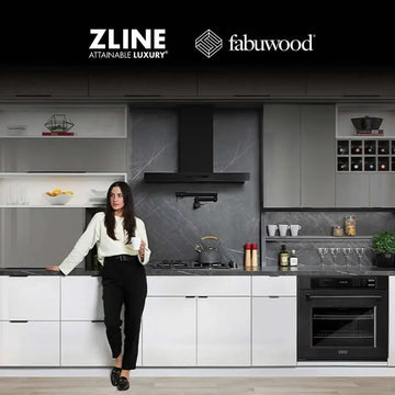 Woman standing in a modern kitchen featuring ZLINE appliances and sleek white and grey Fabuwood cabinetry.