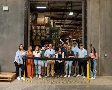 ZLINE team members holding a ribbon-cutting ceremony in front of their expanded Reno, Nevada warehouse facility.
