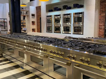 Professional stainless steel ZLINE range and wall ovens in a modern kitchen set from Netflix's Pressure Cooker.