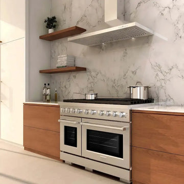 Stainless steel ZLINE 48-inch gas range with brass burners in a modern kitchen with marble backsplash and wood cabinets.