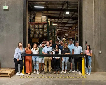 ZLINE team members holding a ribbon-cutting ceremony in front of their expanded Reno, Nevada warehouse facility.