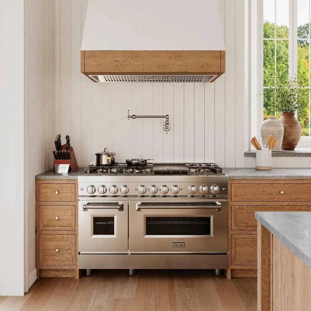 ZLINE Rembrandt Pot Filler in Chrome (REM-FPF-CH) above a large range in a farmhouse-style kitchen, front.
