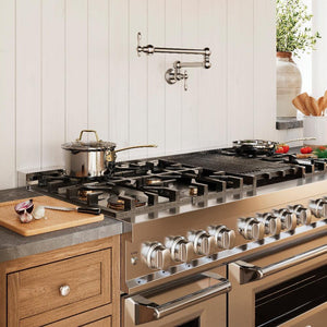 ZLINE Rembrandt Pot Filler in Chrome (REM-FPF-CH) above a large range in a farmhouse-style kitchen, side.