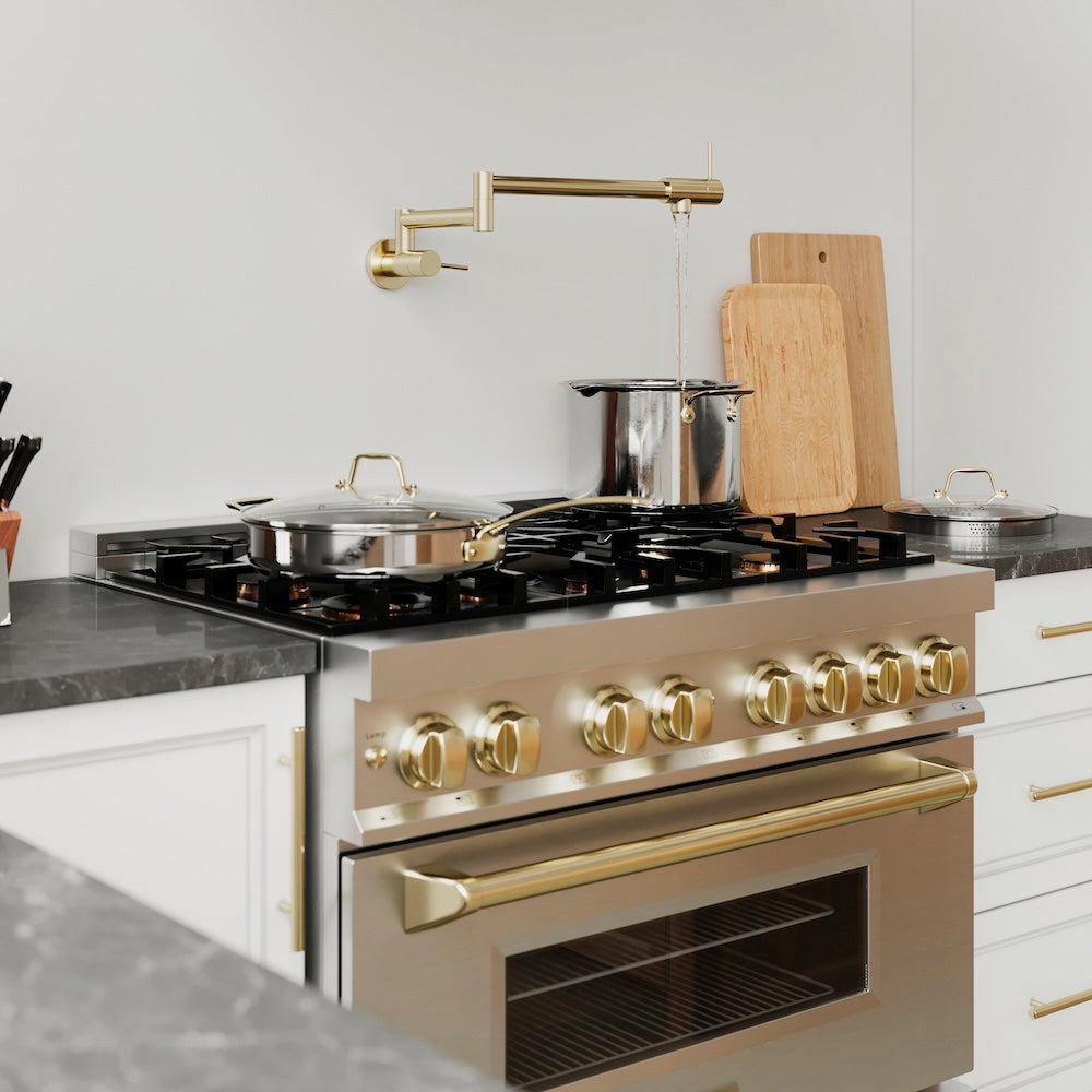 ZLINE Gemini Pot Filler in Polished Gold (GEM-FPF-PG) above a Stainless steel range with gold knobs in a modern kitchen setting, on.