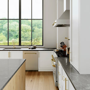 Modern kitchen with large windows, white cabinets, and ZLINE Autograph Edition 24 in. Tallac Series 3rd Rack Top Control Built-In Tall Tub Dishwasher in Stainless Steel with Champagne Bronze Handle, 51dBa (DWVZ-304-24-CB).