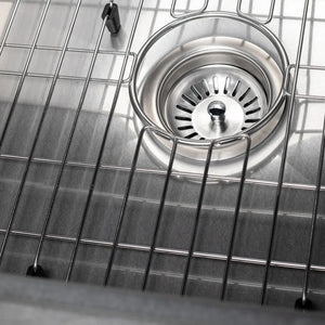 Metal sink strainer inside a ZLINE 30 in. Zermatt Farmhouse Apron Mount Single Bowl Satin Stainless Steel Kitchen Sink with Bottom Grid (SAS-30S)