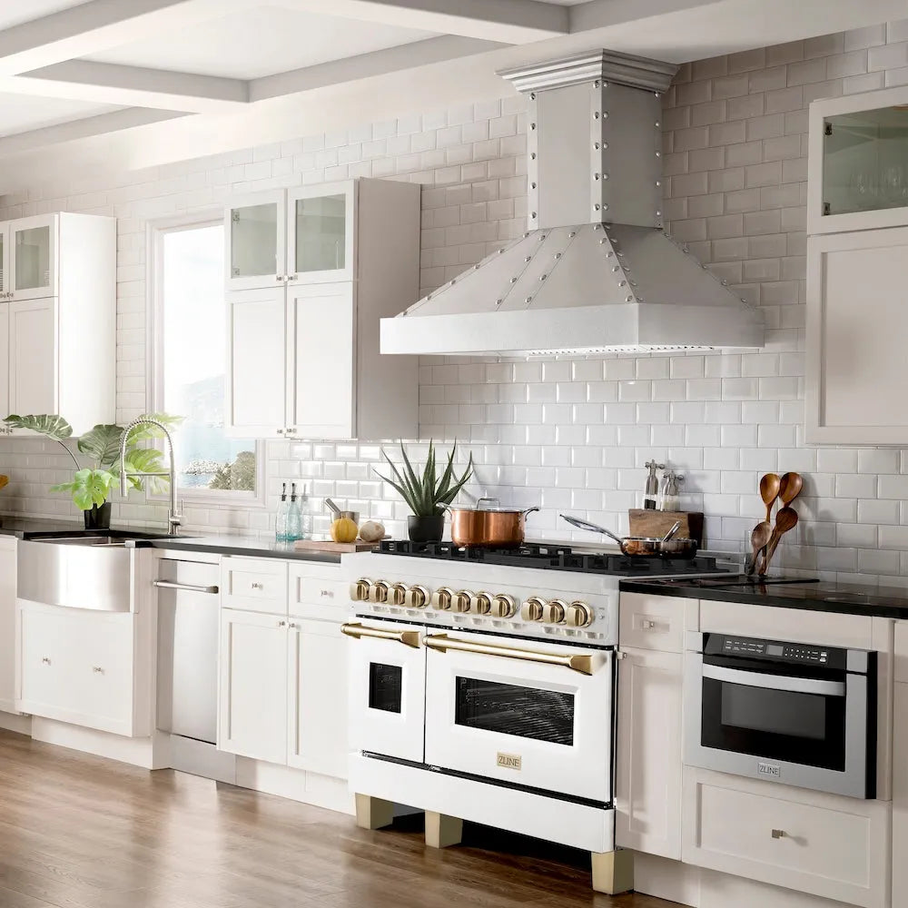 Farmhouse kitchen with ZLINE Autograph Edition 48 in. 6.0 cu. ft. Legacy Dual Fuel Range with 7 Burner Gas Cooktop and 2 Electric Ovens in Satin Stainless Steel with White Matte Doors and Polished Gold Accents (RASZ-WM-48-G), white cabinets, stainless steel appliances, and a white tiled backsplash.