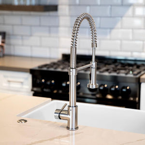 ZLINE Apollo Pull Down Spring Single Handle Kitchen Faucet in Brushed Nickel (APL-KF-BN) in a luxury kitchen, behind.