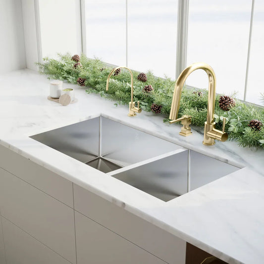 ZLINE Chamonix 33 in. Undermount Double Bowl Stainless Steel Kitchen Sink with Bottom Grid (SR60D-33) in a modern luxury kitchen with gold faucets.