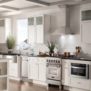 Farmhouse kitchen with white cabinets, ZLINE 24 in. CrownSound™ Ducted Vent Wall Mount Range Hood in Stainless Steel with Built-in Bluetooth Speakers (KBCRN-BT-24), and decorative elements.