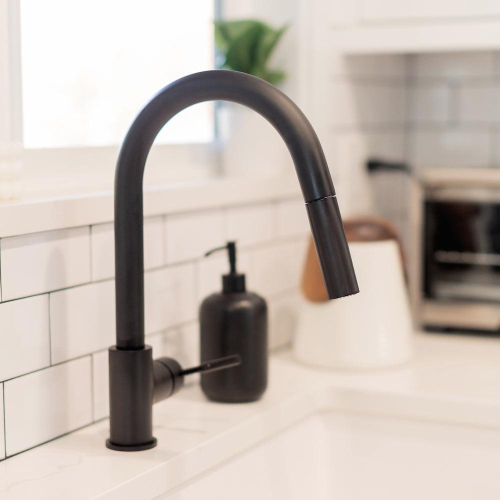 ZLINE Gemini Pull Down Kitchen Faucet in Matte Black (GEM-KF-MB) close-up, in a white cottage-style kitchen, side.