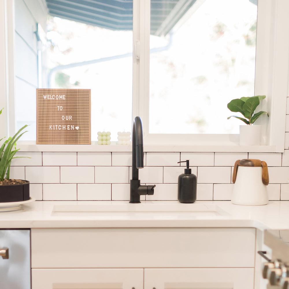 ZLINE Gemini Pull Down Kitchen Faucet in Matte Black (GEM-KF-MB) in a white cottage-style kitchen, front.