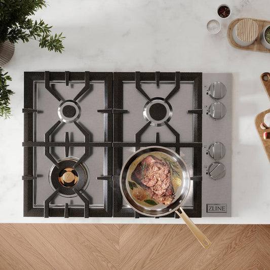 ZLINE 30 in. Gas Cooktop with 4 Brass Burners (RC-BR-30) from above, built-into a white countertop with food cooking on lower right burner.