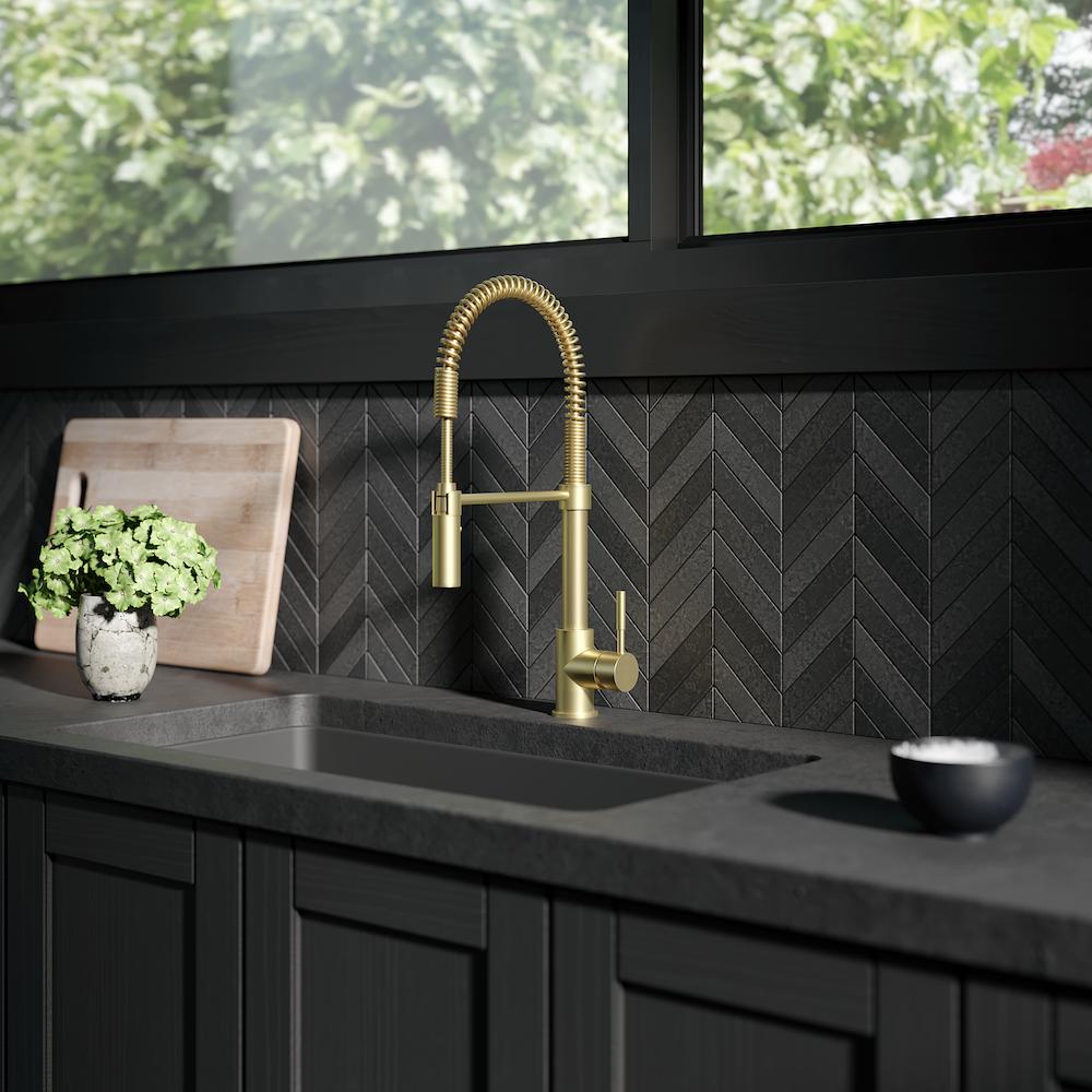 ZLINE Sierra Pull Down Spring Single Handle Kitchen Faucet in Champagne Bronze (SRA-KF-CB) in a kitchen with dark details.