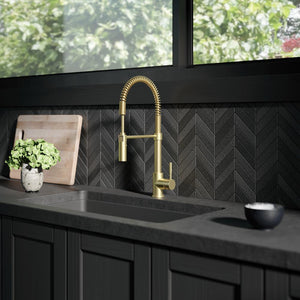 ZLINE Sierra Pull Down Spring Single Handle Kitchen Faucet in Champagne Bronze (SRA-KF-CB) in a kitchen with dark details.