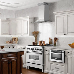 Farmhouse kitchen with white cabinets, ZLINE 30 in. CrownSound™ Ducted Vent Wall Mount Range Hood in Stainless Steel and Glass with Built-in Bluetooth Speakers (KNCRN-BT-30), and wooden accents.
