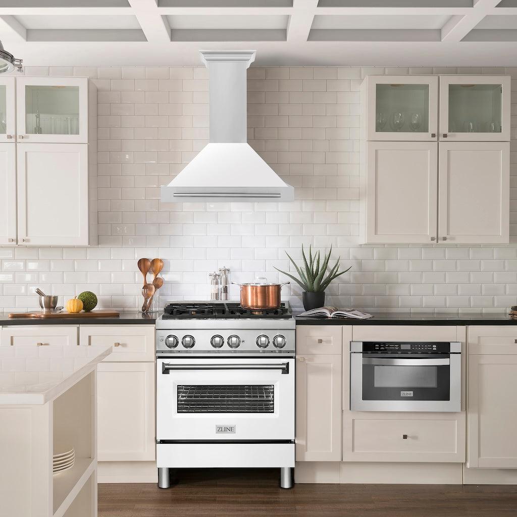 ZLINE Convertible Stainless Steel Range Hood with White Matte Shell and Stainless Steel Handle (KB4STX-WM) in a luxury compact kitchen with matching range and microwave, front.