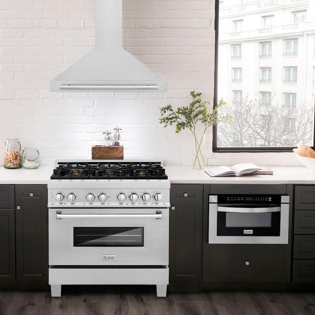 ZLINE Convertible Fingerprint Resistant DuraSnow® Stainless Steel Range Hood with Stainless Steel Handle (KB4SNX) in a luxury compact kitchen with matching range and microwave, front.