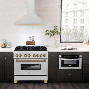 ZLINE Autograph Edition Convertible Fingerprint Resistant DuraSnow® Stainless Steel Range Hood with Champagne Bronze Handle (KB4SNZ-CB) in a luxury compact kitchen with matching range and microwave, front.