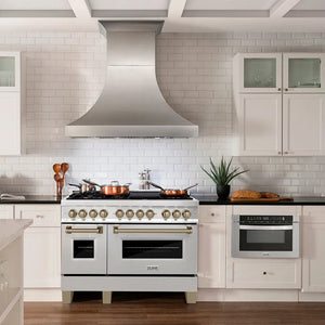 Modern farmhouse kitchen with a ZLINE Autograph Edition 48 in. 6.0 cu. ft. Legacy Dual Fuel Range with 7 Burner Gas Cooktop and 2 Electric Ovens in Satin Stainless Steel and Champagne Bronze Accents (RASZ-SN-48-CB) and oven, white cabinets, and black countertops.
