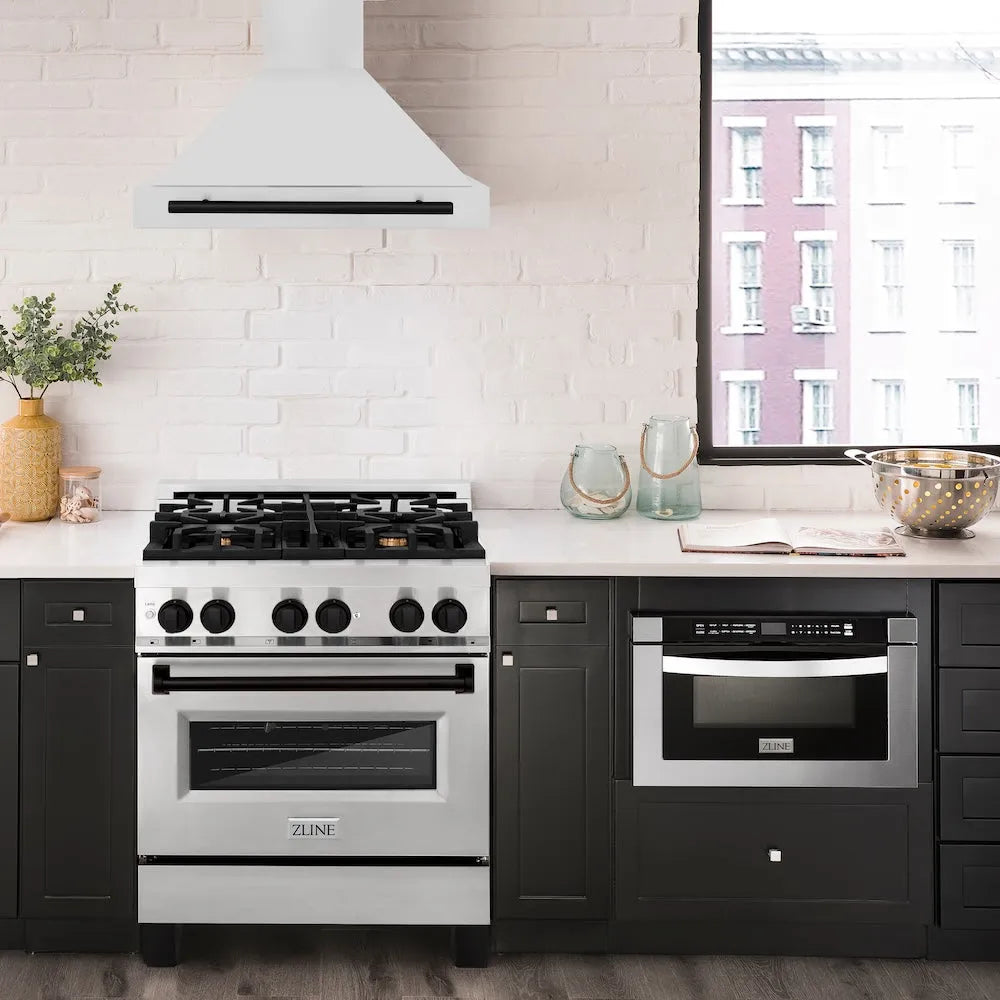 Modern kitchen with a range, ZLINE Autograph Edition 30 in. Convertible Stainless Steel Range Hood with Stainless Steel Shell and Matte Black Accents (KB4STZ-30-MB), and a microwave oven against a white brick wall.