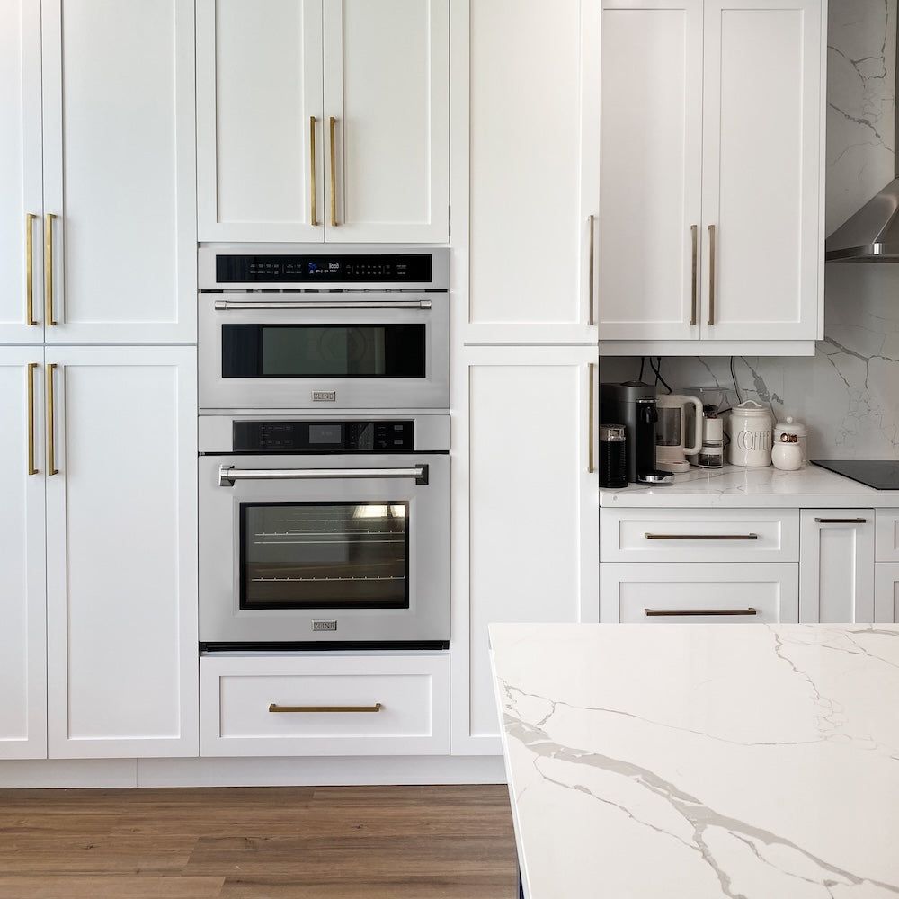 Modern kitchen with ZLINE 30 in. Professional True Convection Single Wall Oven with Air Fry and Self Clean in Stainless Steel (WAS-30), white cabinets, marble countertop, and stainless steel appliances.