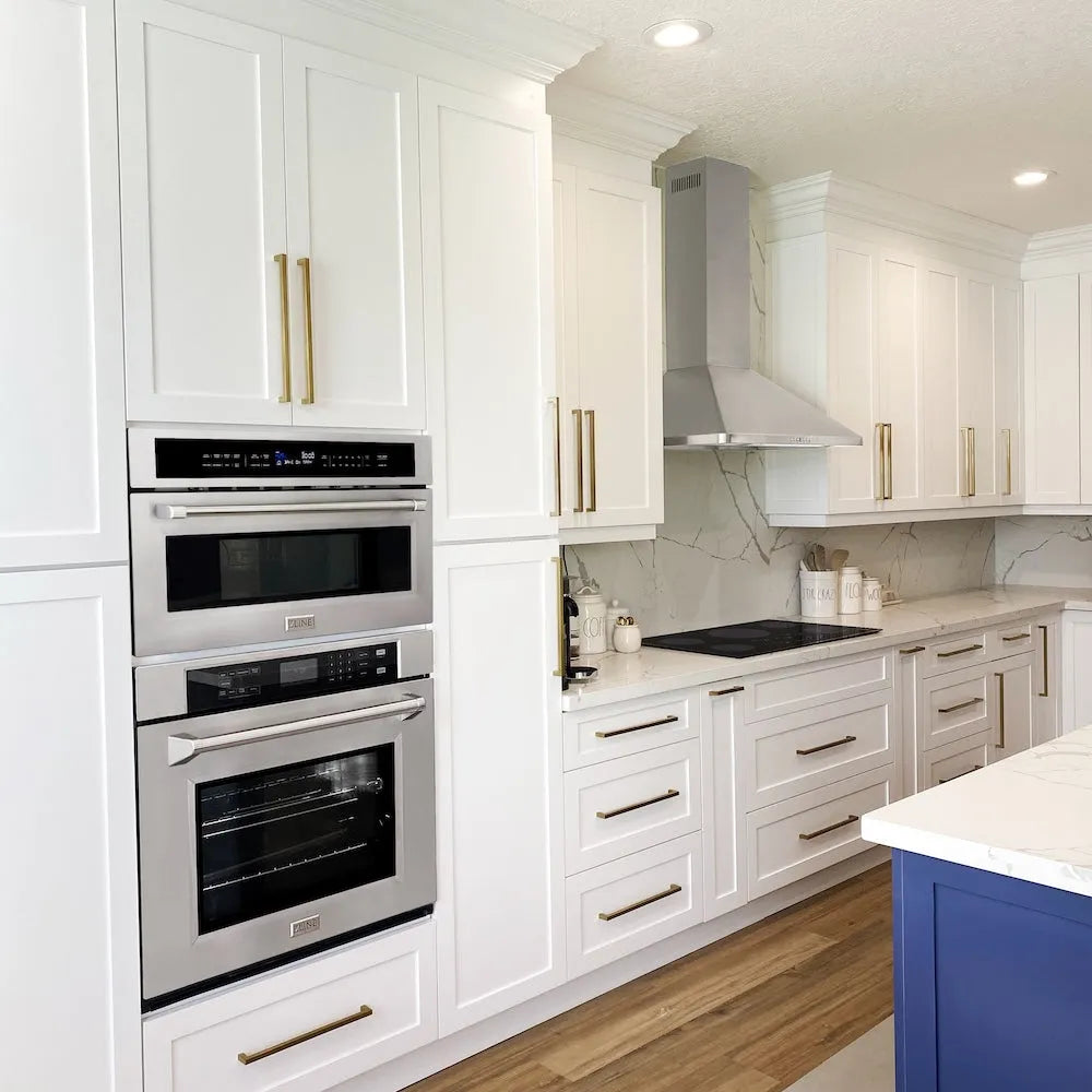 Modern kitchen with white cabinets, ZLINE 30 in. Professional True Convection Single Wall Oven with Air Fry and Self Clean in Stainless Steel (WAS-30), and a blue island.