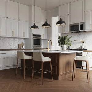 ZLINE Gemini Pot Filler in Champagne Bronze (GEM-FPF-CB) in a kitchen with white cabinets, marble countertops, and wooden island.