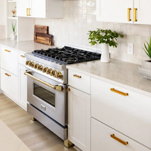 Farmhouse kitchen with white cabinetry, gold handles, and a ZLINE Autograph Edition 36 in. 4.6 cu. ft. Legacy Dual Fuel Range with 6 Burner Gas Cooktop and Electric Convection Oven in Stainless Steel and Polished Gold Accents (RAZ-36-G)