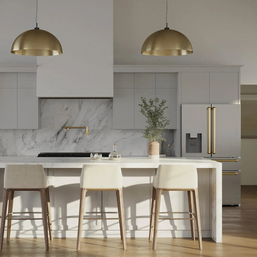 Modern kitchen with marble backsplash, gold fixtures, white island, and a large custom range hood using a ZLINE 46 in. Ducted Wall Mount Range Hood Insert in Stainless Steel (695-46).