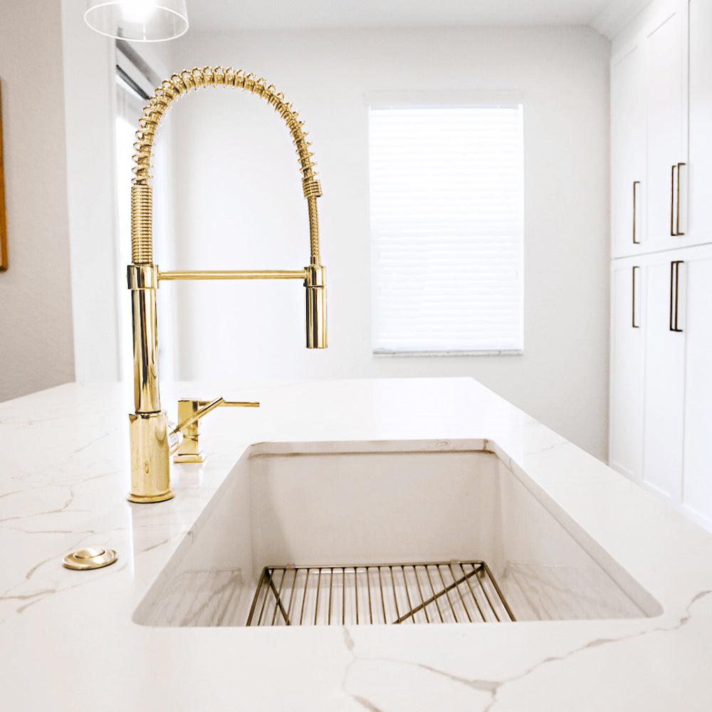 ZLINE Sierra Pull Down Spring Kitchen Faucet in Polished Gold (SRA-KF-PG) in an immaculate white kitchen, side.