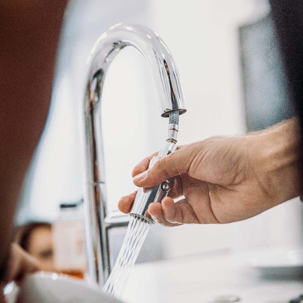 ZLINE Voltaire Kitchen Faucet in Chrome (VLT-KF-CH) using the pull-down spray wand.