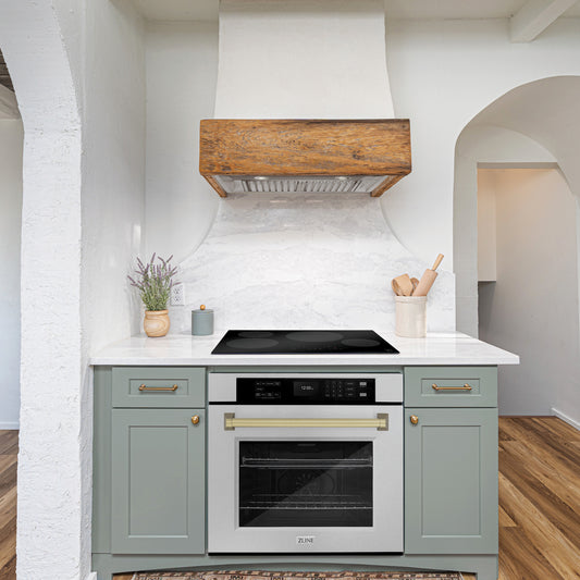 ZLINE Autograph Edition 30 in. Professional True Convection Single Wall Oven with Air Fry and Self Clean in DuraSnow® Stainless Steel with Champagne Bronze Handle (WASSZ-30-CB) lifestyle in a rustic kitchen below induction cooktop with custom range hood.