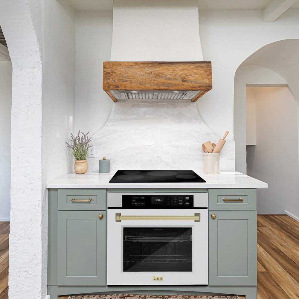 ZLINE Autograph Edition 30 in. Professional True Convection Single Wall Oven with Air Fry and Self Clean in DuraSnow® Stainless Steel with White Matte Door and Champagne Bronze Handle (WASSZ-WM-30-CB) lifestyle in a rustic kitchen below induction cooktop with custom range hood.