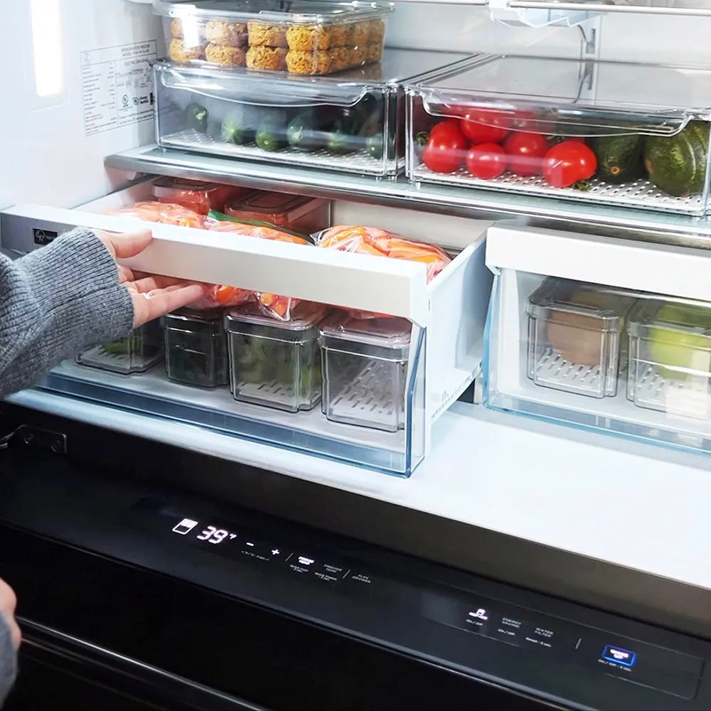 Person reaching into a modern ZLINE 36 in. 21.6 cu. ft. Counter-Depth French Door Refrigerator with Water and Ice Dispenser in Fingerprint-Resistant Black Stainless Steel (RFM-W-36-BS) with multiple compartments filled with food.