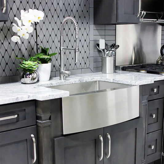 ZLINE Zermatt 30 in. Farmhouse Apron Mount Single Bowl Stainless Steel Kitchen Sink with Bottom Grid (SAS-30) close-up, in a luxury kitchen.