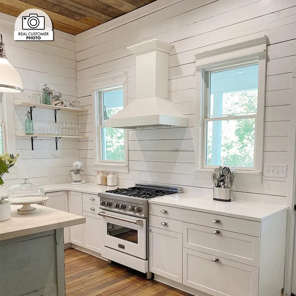 Cottage kitchen with white cabinets, ZLINE 30 in. Ducted Wooden Wall Mount Range Hood in Cottage White (KBTT-30), stainless steel range, and wooden floor.