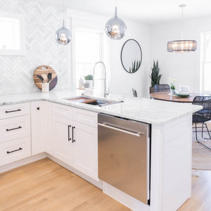 ZLINE Garmisch 33 in. Undermount Single Bowl Stainless Steel Kitchen Sink with Bottom Grid and Accessories (SLS-33) in a white cottage-style kitchen with chrome faucet, wide.