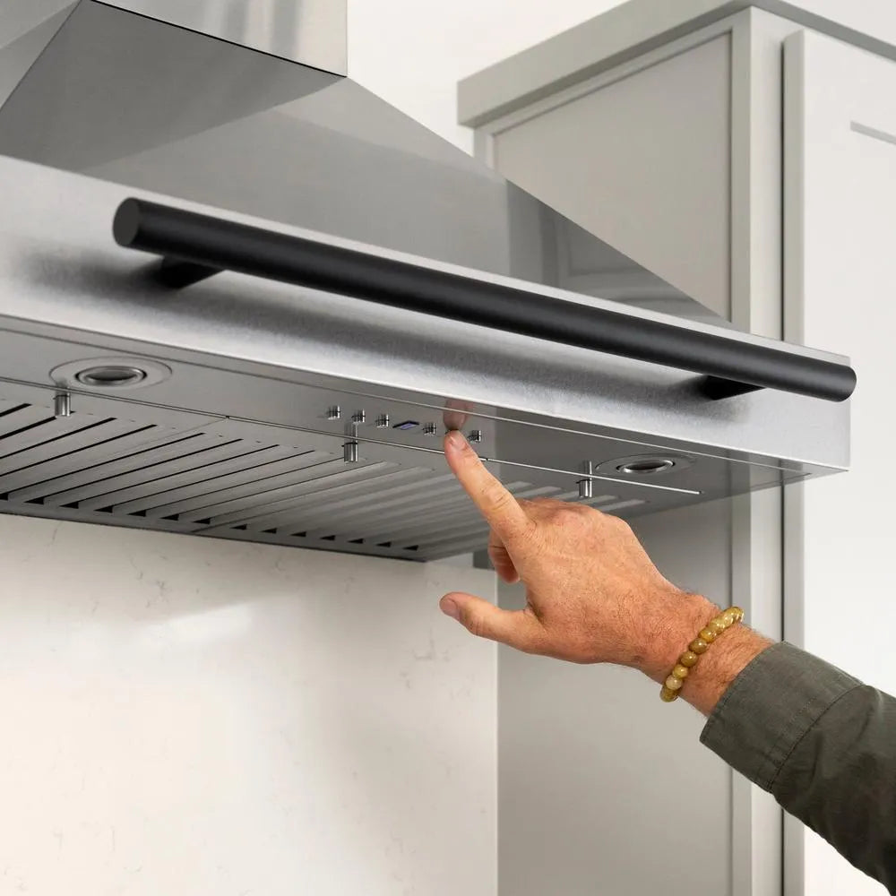 Hand pressing a button on ZLINE Autograph Edition 30 in. Convertible Stainless Steel Range Hood with Stainless Steel Shell and Matte Black Accents (KB4STZ-30-MB)