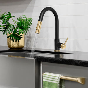 ZLINE Autograph Edition Gemini Pull Down Single Handle Kitchen Faucet in Matte Black and Champagne Bronze (GEM-KF-ZMBCB) in a luxury kitchen, water on.