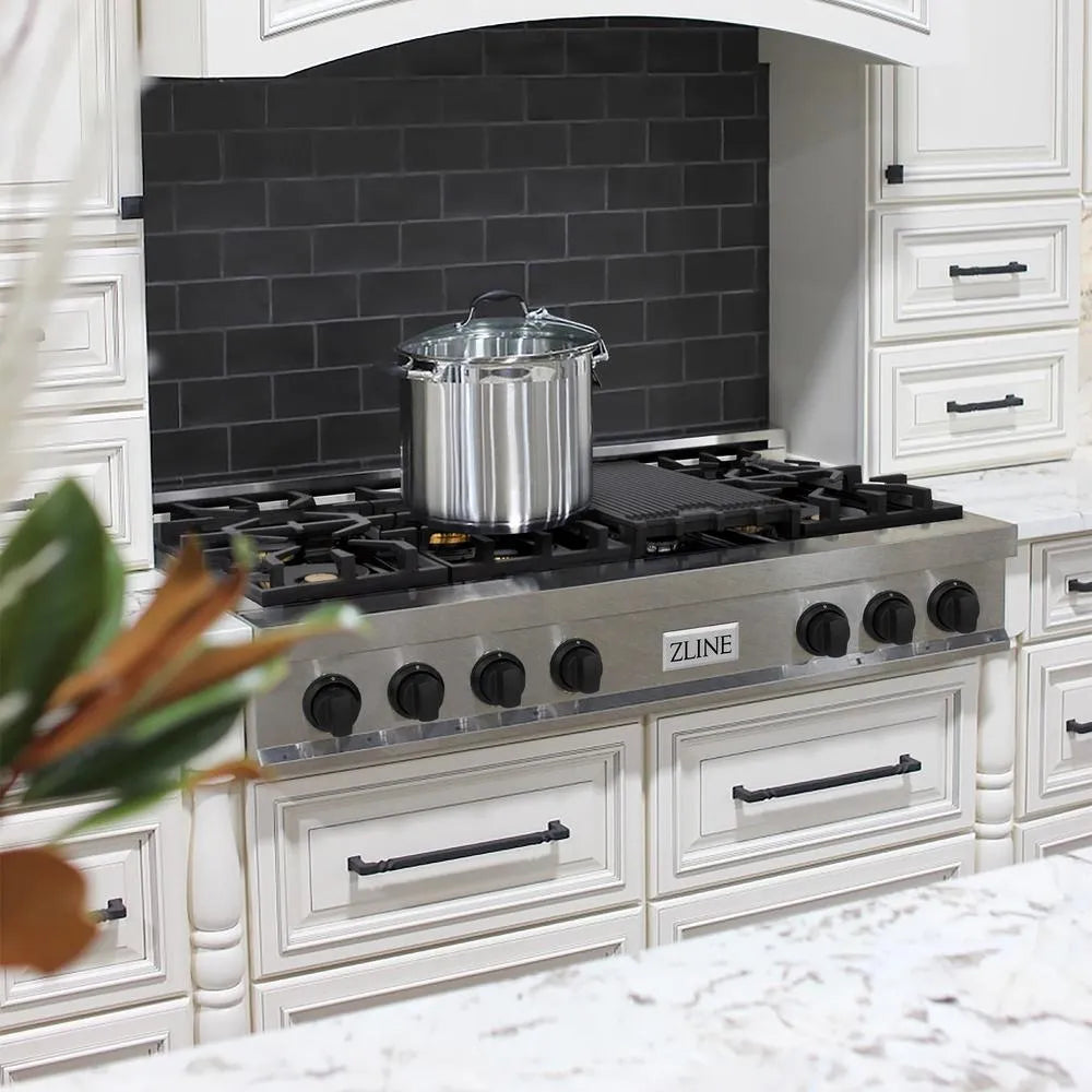 ZLINE Autograph Edition 48 in. Legacy Gas Rangetop with 7 Burners and Porcelain Cooktop in Satin Stainless Steel with Matte Black Accents (RTSZ-48-MB) in a farmhouse kitchen with white cabinets, marble countertops, and decorative elements.